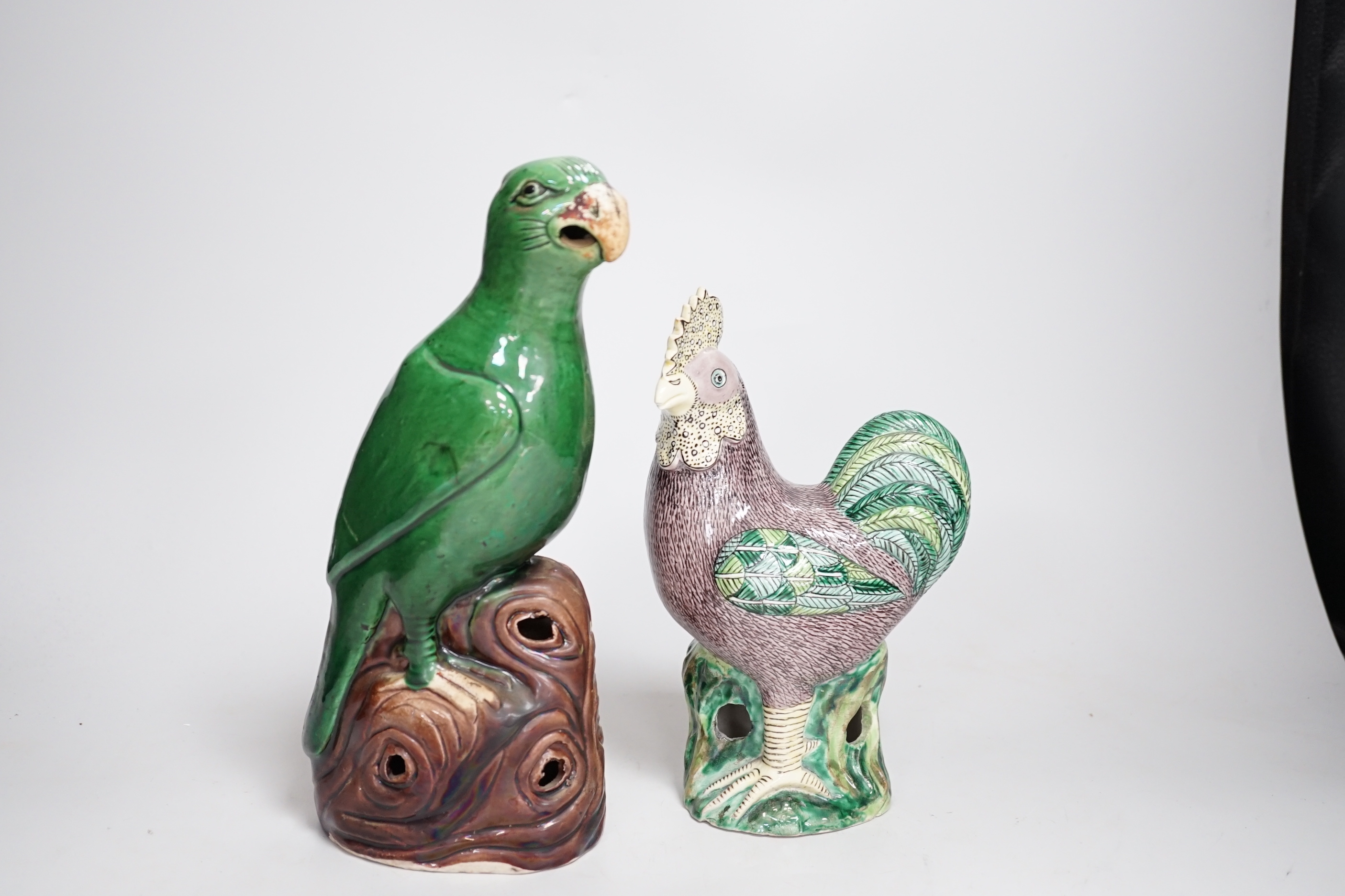 A Chinese green glazed model of a parrot, late 19th century and an early 20th century Chinese model of a cockerel, the largest 27cm high